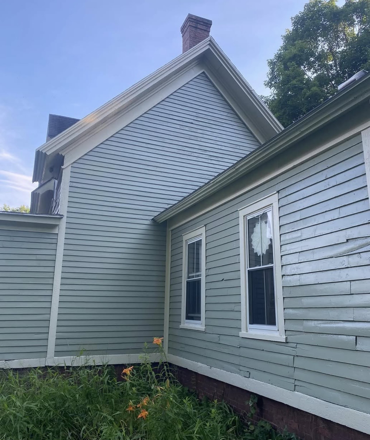 Wood siding after being painted green