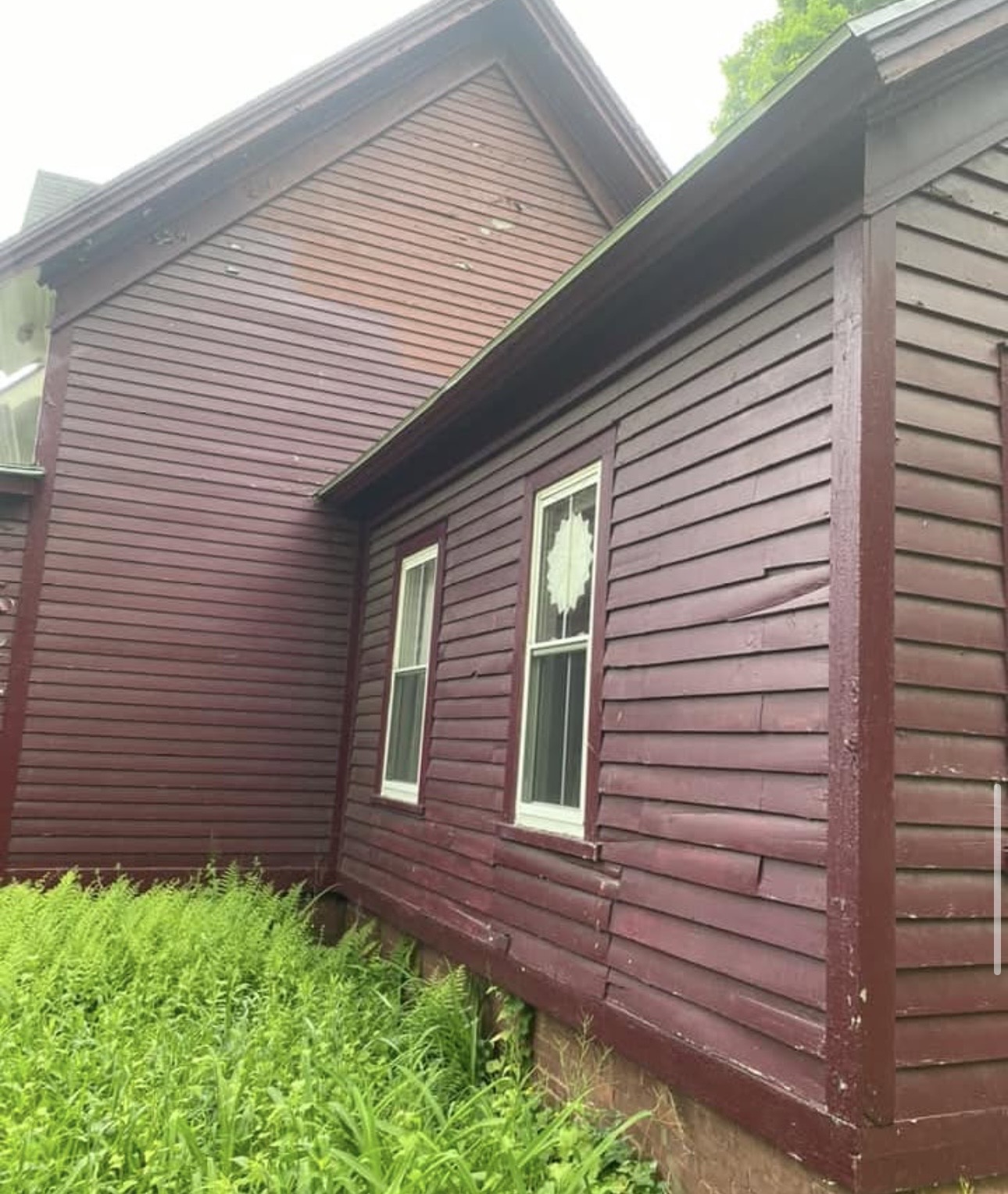 Red wood siding before exterior painting